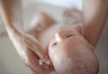 What is the ideal water temperature for bathing the baby?