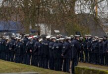 Second victim buried after police murders