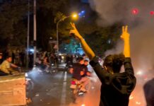 Why do women protest in Iran by burning their veils?